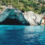 The Blue Caves in Paxos, Greece - famous sea caves in the Ionian Sea with stunning clear blue water for swimming and boat tours